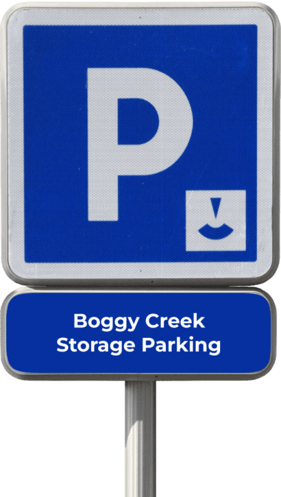 Parking sign with a white "P" on a blue background, arrow pointing down, and text "Boggy Creek Storage Parking" on a lower panel.